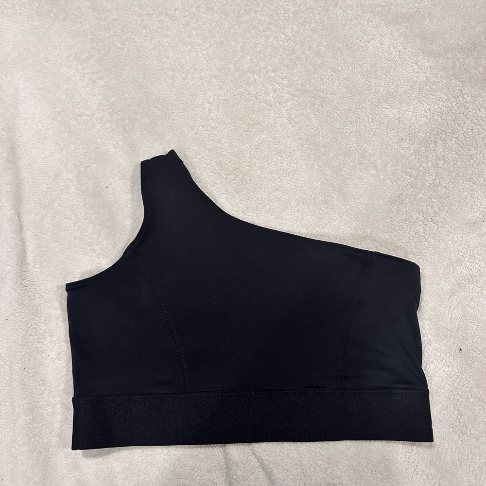 One shoulder bra. Strap is on right shoulder. Looks new.
